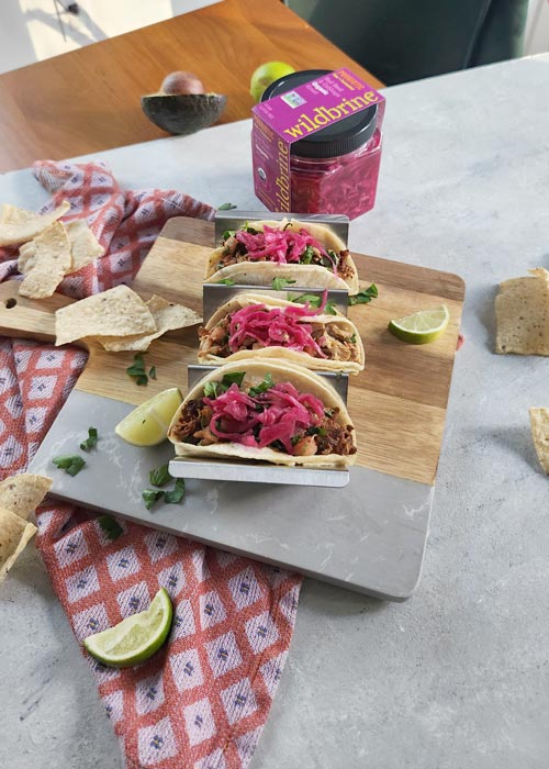 Three pork tacos with toppings