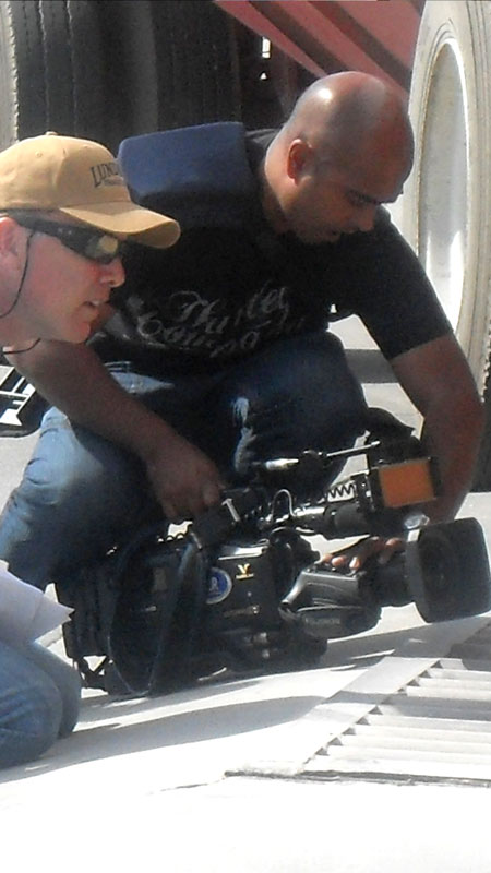 Filming production crew with camera